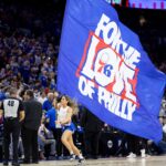 May 2, 2024; Philadelphia, Pennsylvania, USA; Philadelphia 76ers entertainer runs with a large flag during the first half of game six of the first round for the 2024 NBA playoffs against the New York Knicks at Wells Fargo Center. Mandatory Credit: Bill Streicher-USA TODAY Sports Tyrese Maxey